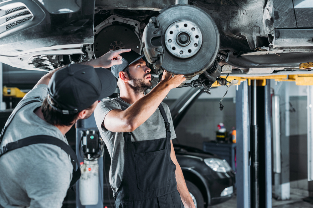 Mechaniker arbeitet in einer freien Kfz-Werkstatt an einem Auto